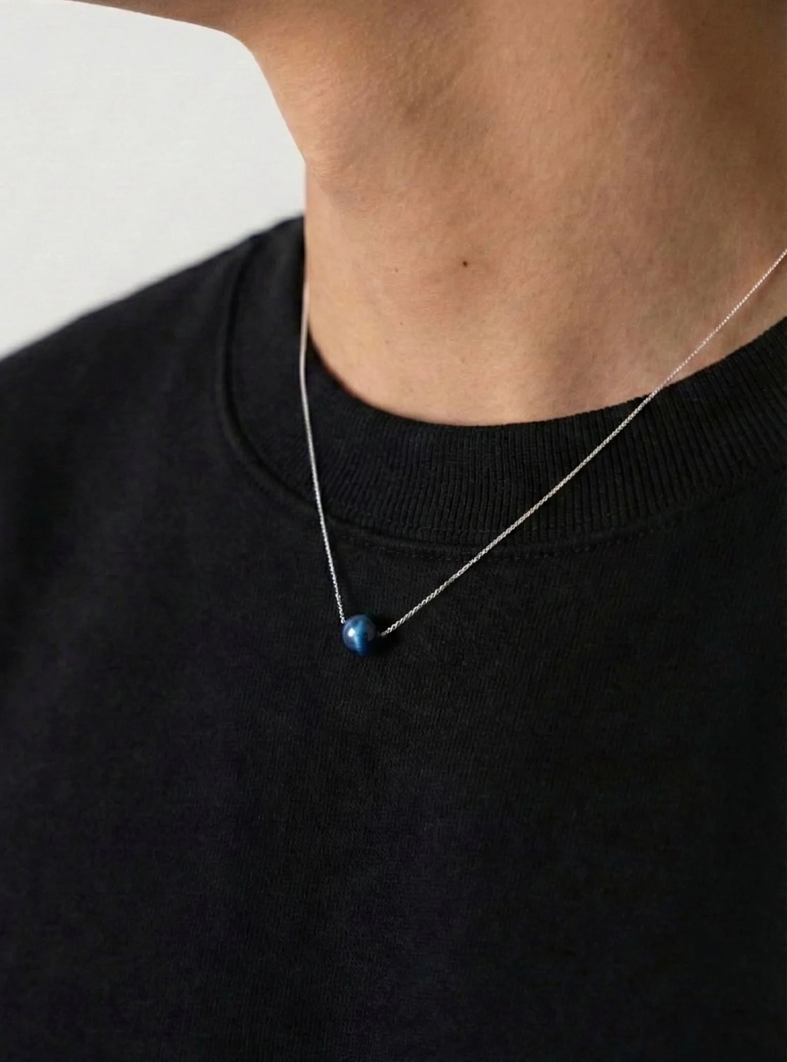 BLUE PEARL necklace worn at the neckline